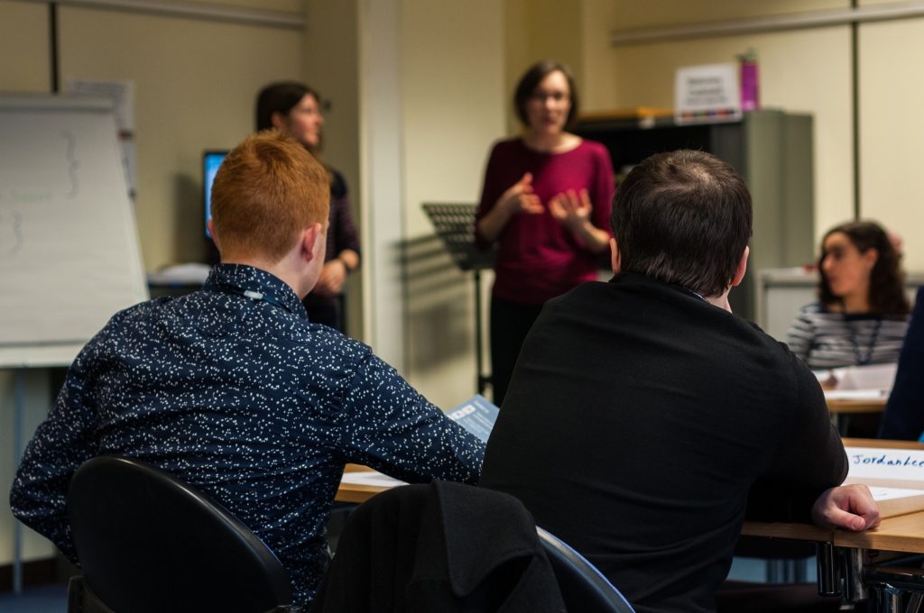 2 people listening to a presentation